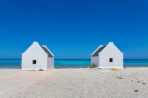 Two white slave houses by the sea off the island of Bonaire