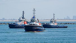 Three harbour tugs are waiting for a supertanker. by Jaap van den Berg