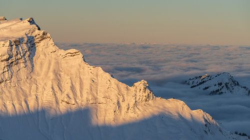 Sunrise on the Hählekopf peak with a view of Diedamskopf in winter