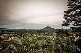 A vast rural landscape beneath Mount Sinabung by Frank Photos