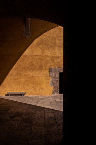 Bench in front of an orange wall