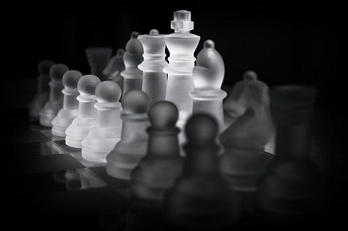 White Glass Chess Pieces on Game Board
