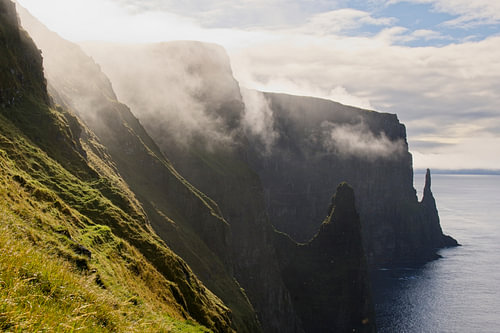 Mist drifts away over the cliff-lined coast