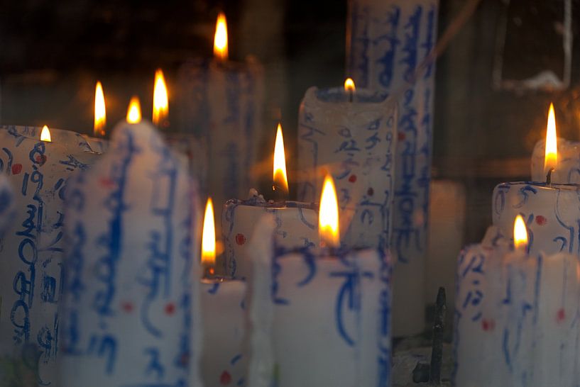 Burning temple candles by Mw. Monique