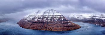 Panorama of the Faroe Islands fjord and snowy mountains