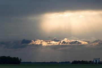 Sun rays and clouds by Anjo ten Kate