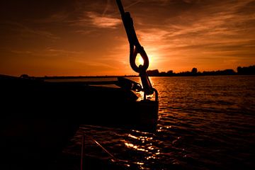 Zonsondergang door de giek van Hilda Koopmans