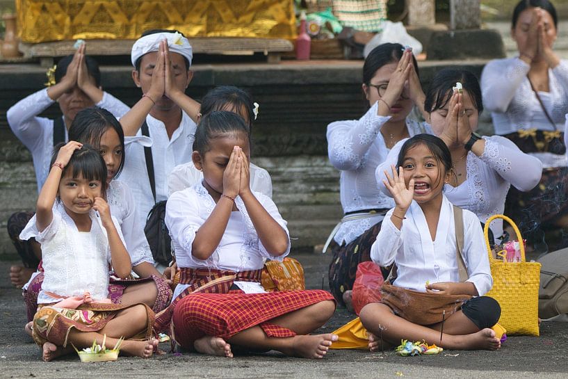 Waving girls during a ceremony at the temple by Anne Ponsen