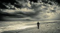 Man lonely on beach with storm clouds in black and white by Dieter Walther thumbnail