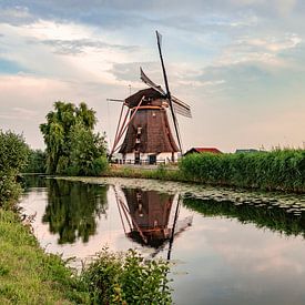 Mill in picturesque Dutch landscape by quiet water by Mirjam Brozius