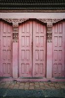 Alte rosa Holztür. Pastellfarbene Architektur