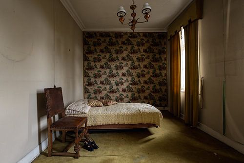 The shoes are still beside the bed in this dilapidated mansion.