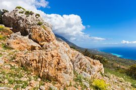 Orange rocks on mountain at greek coast by Ben Schonewille