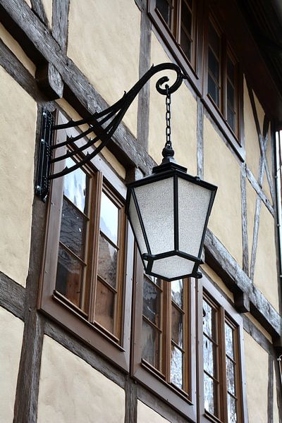 Lantern in front of a historical half-timbered house in the old town of Wernigerode by Heiko Kueverling