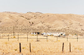 A secluded ranch set against the golden hills of the Canadian outback by Tom Tewes