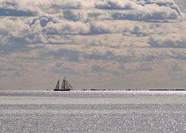 Sailing boat on a silver Wadden Sea by Arie Jan van Termeij