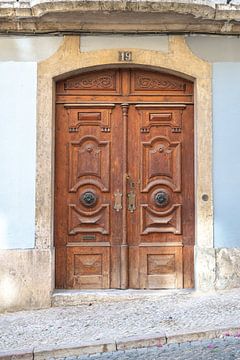 Brown wooden double door in Alfama, Lisbon, Portugal by Christa Stroo photography