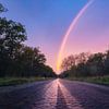 Regenboog bij zonsopkomst In Meijendel van Paul Poot