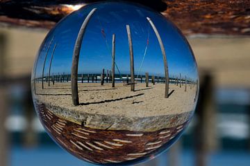 The swing in the middle of the palm village, through the lens ball. by Corine Dekker