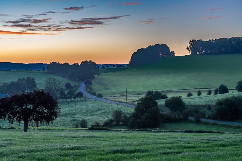 Colorful sunrise on a misty morning between the meadows near castle buesdaal by Kim Willems