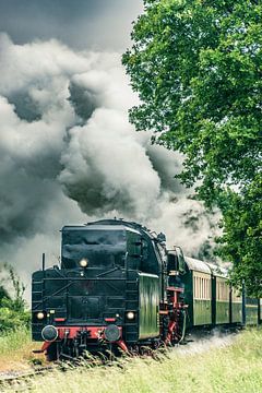 Old steam train with a lot of smoke coming from the chimney