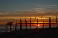 Sunrise behind the jetty of the Waddenveer