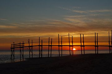 Sunrise behind the jetty of the Waddenveer by Wim van der Geest
