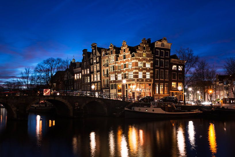 Amsterdam canal houses illuminated at dusk by iPics Photography