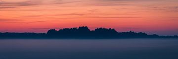 Misty Enchantment: Golden Hour Sky over Foggy Landscape by AVP Stock