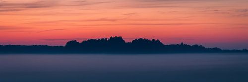 Misty Enchantment: Golden Hour Sky over Foggy Landscape