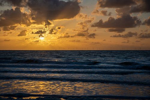Coucher de soleil sur la plage de La Haye, avec les éoliennes offshore à l'horizon. sur Jan Fritz
