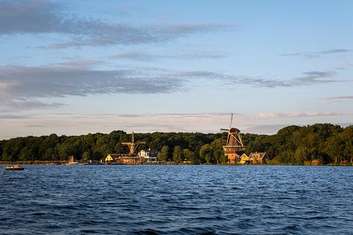 Sunset with Dutch windmill in the waters of Kralingse Plas, Rotterdam, Netherlands