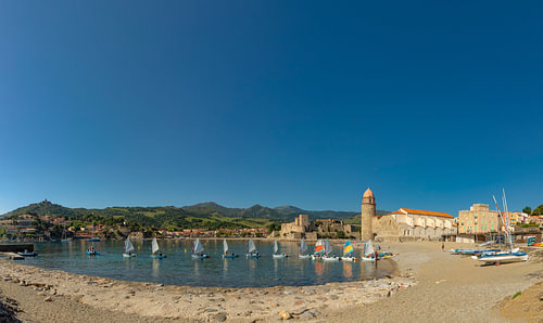 Saint Vincent beach, small sailing boats, the old lighthouse and Anse de la Baleta bay, Collioure, P by Rene van der Meer