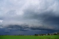 Rolling cloud with lots of precipitation and a village