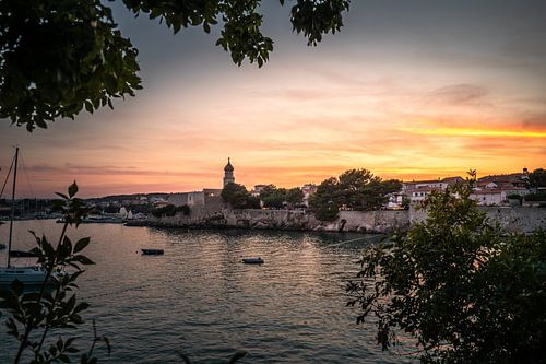Uitzicht door bomen op de oude stad van Krk, Kroatië