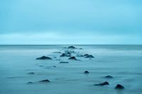 Stones in the dense fog on the beach in Texel in the Netherlands.