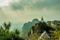 Sunbeams on the temples on the mountains nearby Lampang Thailand