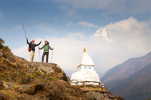 Mountain hikers with Buddhist Stupa on Everest Base Camp Trek in Nepal