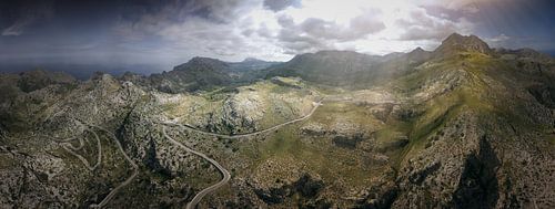 Aerial view of a winding mountain landscape in the sunshine