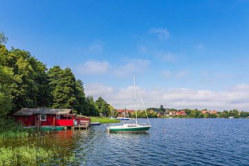 View of boathouses and sailing boats in the town of Zarrentin am by Rico Ködder