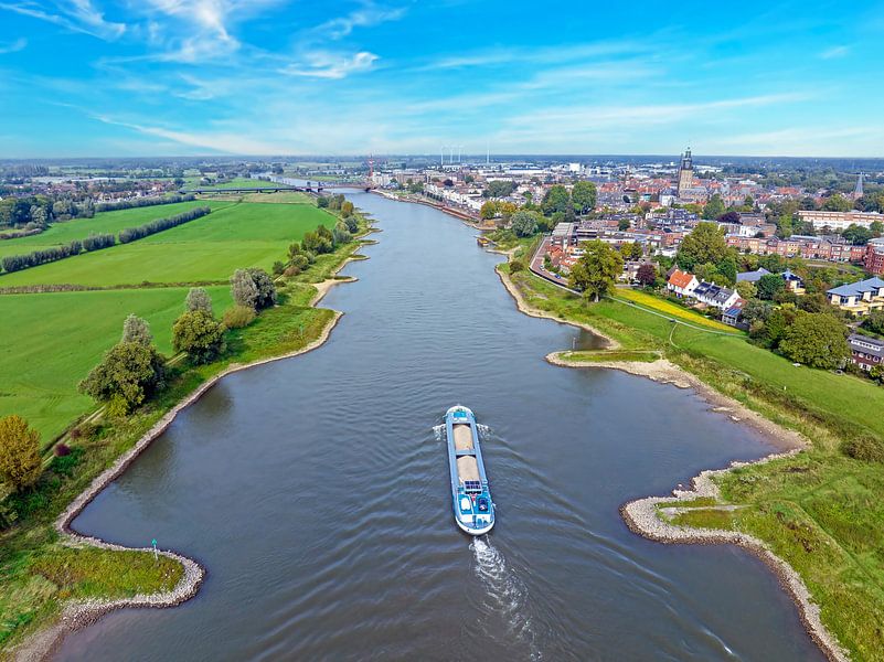 Cargo ship sailing on the river IJssel near Zutphen in the Netherlands by Eye on You