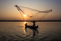 Fishermen on the river near Mandalay in Myanmar. Old-fashioned way of fishing. 