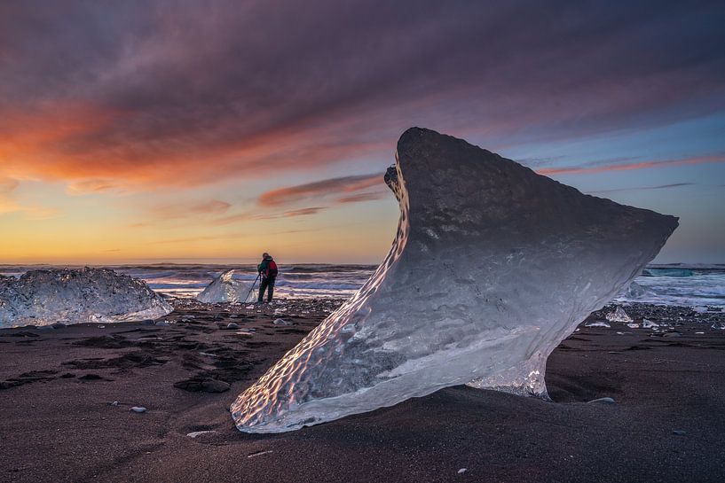 Sunrise on the Diamond beach, near Lake Jokulsarlon glacier, with a photographer on the beach behind by Anges van der Logt
