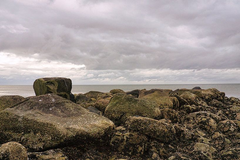 Stone groyne juts into the sea on a sandy beach in Denmark by Martin Köbsch