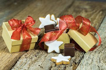 Sweet christmas gift with star biscuits and chocolate on wooden table by Alex Winter