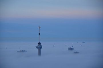 Euromast and Harbour cranes above the Mist. by Marcel van Duinen