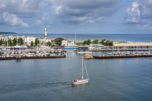 Lighthouse and sailing boat on the Baltic coast in Warnemünde
