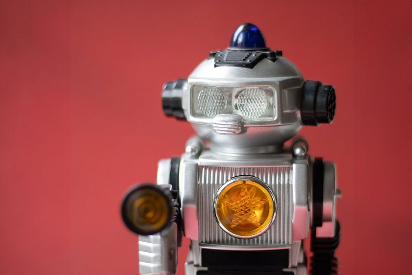 Vintage toy robot on red by Jolanda Grutter