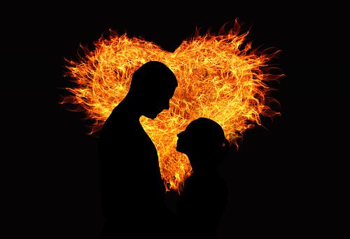 Man and woman in from of a heart of fire