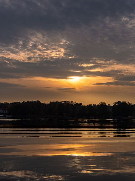 Sunset over the house lake in the town Feldberg by Rico Ködder